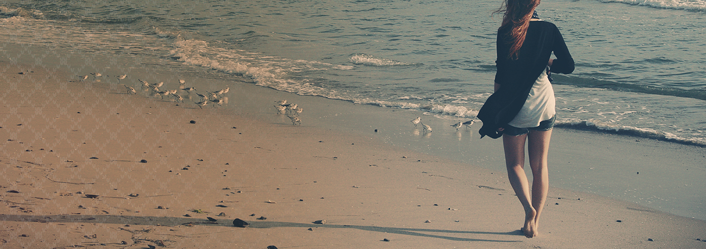 woman wearing wool walking on the beach